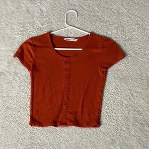 Button but orange shirt